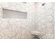 Walk-in shower featuring marble-style hexagon tile with a shower bench and niche at 5215 Star Magnolia Ct, Clover, SC 29710