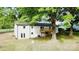 Exterior view of a home with a wooden balcony, seen from the backyard and mature trees at 5520 Chestnut Dr, Hickory, NC 28602