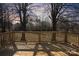 Relaxing wooden deck offering a serene view of the surrounding woods and a beautiful sunset at 5520 Chestnut Dr, Hickory, NC 28602