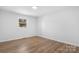 Empty bedroom featuring a single window and wood laminate flooring at 5520 Chestnut Dr, Hickory, NC 28602
