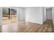 Bright, empty bedroom features wood-look flooring and sliding glass door access to a wooden deck at 5520 Chestnut Dr, Hickory, NC 28602