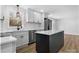 Open kitchen featuring white cabinets, stainless steel appliances, a large island, and wood flooring at 5520 Chestnut Dr, Hickory, NC 28602