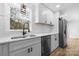 Bright kitchen with stainless steel appliances, white cabinets, subway tile backsplash, and modern fixtures at 5520 Chestnut Dr, Hickory, NC 28602