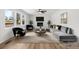 Bright living room with a decorative fireplace, modern furniture, and large windows offering great natural light at 5520 Chestnut Dr, Hickory, NC 28602