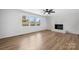 Open living room featuring hardwood floors, a decorative fireplace, and large windows providing ample natural light at 5520 Chestnut Dr, Hickory, NC 28602