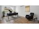 Home office with dark wood-look floors, an accent rug, a desk, and a comfortable chair at 5520 Chestnut Dr, Hickory, NC 28602