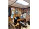 Functional basement workspace with wood-paneled walls, a large desk, and ample storage space for productivity at 5806 Whitingham Dr, Charlotte, NC 28215