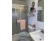 Compact bathroom showcasing a glass-enclosed shower, a toilet, and a vanity with ample storage space at 5806 Whitingham Dr, Charlotte, NC 28215