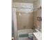 Classic bathroom with floral wallpaper, a bathtub with a shower, and essential fixtures for convenience at 5806 Whitingham Dr, Charlotte, NC 28215