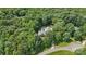 Aerial view of a house surrounded by lush trees and a backyard pool at 5812 Morgan Park Dr, Monroe, NC 28110