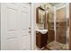 Bathroom with floating vanity, tiled walk-in shower, and a glass door at 5812 Morgan Park Dr, Monroe, NC 28110