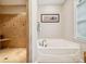Bright bathroom featuring a bathtub and separate tiled shower with neutral color palette at 5812 Morgan Park Dr, Monroe, NC 28110
