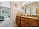 Bathroom vanity with granite countertop and double sinks with adjacent bedroom at 5812 Morgan Park Dr, Monroe, NC 28110