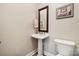 Half-bath featuring pedestal sink, framed mirror and convenient toilet at 5812 Morgan Park Dr, Monroe, NC 28110