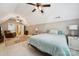 A spacious bedroom with a ceiling fan, recliner, and a large bed with a beautiful area rug at 5812 Morgan Park Dr, Monroe, NC 28110