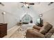 Spacious bonus room with vaulted ceilings, ceiling fans, and a large patterned rug at 5812 Morgan Park Dr, Monroe, NC 28110