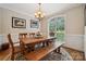 Inviting dining room features a large window, wood table, and beautiful chandelier at 5812 Morgan Park Dr, Monroe, NC 28110