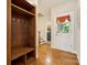 Mudroom with decorative door featuring storage and hardwood floors at 5812 Morgan Park Dr, Monroe, NC 28110