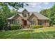 Beautiful brick home with manicured lawn, mature trees, and a welcoming front porch at 5812 Morgan Park Dr, Monroe, NC 28110