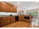 Kitchen with wooden cabinets, granite countertops, and views to the breakfast area at 5812 Morgan Park Dr, Monroe, NC 28110