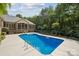 A sparkling blue in-ground pool surrounded by a concrete patio and well-maintained landscaping at 5812 Morgan Park Dr, Monroe, NC 28110