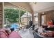 Spacious screened-in porch featuring red seating, brick walls, and a view of the backyard at 5812 Morgan Park Dr, Monroe, NC 28110