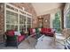 A spacious screened-in porch with ample seating and an exterior brick wall at 5812 Morgan Park Dr, Monroe, NC 28110