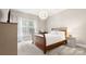 Bright bedroom with a wooden bed frame, and large window at 6129 Caseys Side Way, Fort Mill, SC 29708
