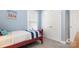 Light blue bedroom with a red bed, and carpeted floors at 6129 Caseys Side Way, Fort Mill, SC 29708