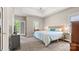 Comfortable bedroom with a tray ceiling, neutral tones, and access to a private balcony at 6129 Caseys Side Way, Fort Mill, SC 29708