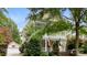 Two-story home with a welcoming front porch and balcony, surrounded by mature trees and lush landscaping at 6129 Caseys Side Way, Fort Mill, SC 29708