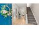 Inviting foyer featuring hardwood floors, staircase, and a glimpse into the living spaces at 6129 Caseys Side Way, Fort Mill, SC 29708
