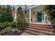 Charming front porch with brick steps, American and community flags, and a welcoming blue door at 6129 Caseys Side Way, Fort Mill, SC 29708