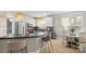 Spacious kitchen featuring a breakfast bar, stainless appliances, and a sunlit breakfast nook at 6129 Caseys Side Way, Fort Mill, SC 29708
