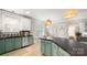 Modern kitchen with stylish sage green cabinets, black countertops, and stainless steel appliances at 6129 Caseys Side Way, Fort Mill, SC 29708
