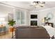 Inviting living room featuring a fireplace, large windows, and a comfortable leather couch at 6129 Caseys Side Way, Fort Mill, SC 29708