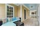 Relaxing porch with blue cushions, glass table, and view of the outdoors at 6129 Caseys Side Way, Fort Mill, SC 29708