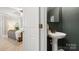 Convenient half bathroom with a pedestal sink and stylish fixtures located near the living area at 6129 Caseys Side Way, Fort Mill, SC 29708