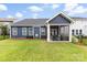 Spacious backyard featuring a well-manicured lawn and a covered patio at 6261 Six String Ct, Fort Mill, SC 29708