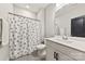 Clean bathroom with patterned shower curtain, vanity, and well lit mirror at 6261 Six String Ct, Fort Mill, SC 29708