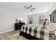 Bedroom featuring a wooden bed, fan, and TV, with a bright window at 6261 Six String Ct, Fort Mill, SC 29708