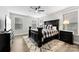 Charming bedroom with a black bed, rug, and decorative lamps on nightstands at 6261 Six String Ct, Fort Mill, SC 29708