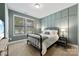 Inviting bedroom with a comfortable bed, soft lighting, and a large window at 6261 Six String Ct, Fort Mill, SC 29708