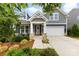 Charming home featuring a landscaped yard, inviting front porch, and a two-car garage at 6261 Six String Ct, Fort Mill, SC 29708