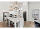 Bright kitchen featuring an island with seating, stainless steel appliances, and stylish light fixtures at 6261 Six String Ct, Fort Mill, SC 29708