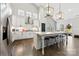 Open-concept kitchen featuring a large island, sleek white cabinetry, and modern stainless steel appliances at 6261 Six String Ct, Fort Mill, SC 29708