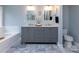 Elegant bathroom featuring a double sink vanity, marble floors, and a luxurious soaking tub for relaxation at 6914 Evanton Loch Rd, Charlotte, NC 28278