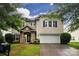 Charming home featuring blue shutters, stone entryway, and two-car garage at 6914 Evanton Loch Rd, Charlotte, NC 28278