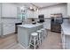Modern kitchen showcasing a marble island with seating, stainless steel appliances, and ample cabinet space at 6914 Evanton Loch Rd, Charlotte, NC 28278