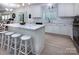 Open kitchen featuring an island with seating, white cabinets, and stainless steel appliances at 6914 Evanton Loch Rd, Charlotte, NC 28278